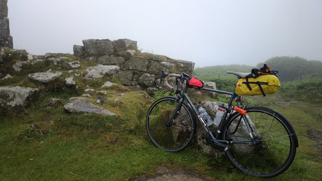 Bike by ruins in the mist